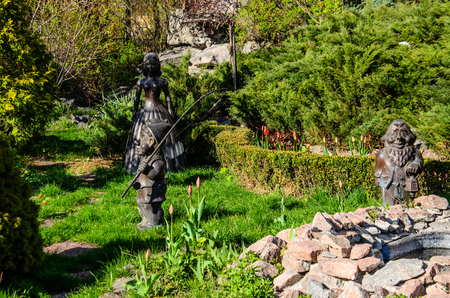 Sculpture of the dwarfs and snow white in city parkの写真素材