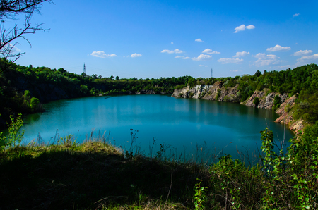 Beautiful lake in abandoned granite quarry on springの写真素材