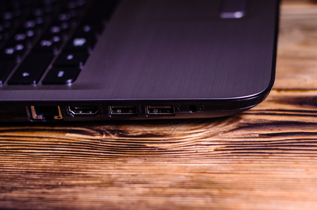 Modern laptop on the rustic wooden tableの写真素材