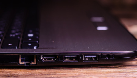 Modern laptop on the rustic wooden tableの写真素材