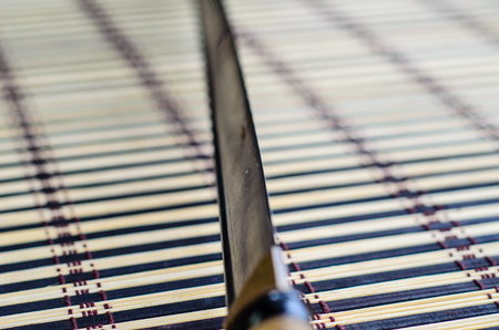 Japanese sword katana on a bamboo mat. Selective focusの写真素材