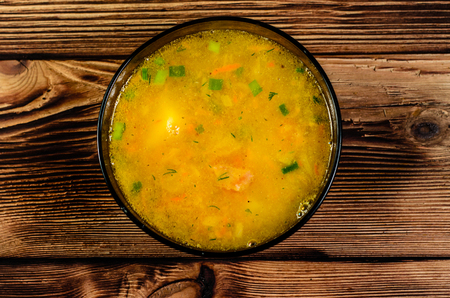 Vegetable soup in glass bowl on wooden table. Top viewの写真素材