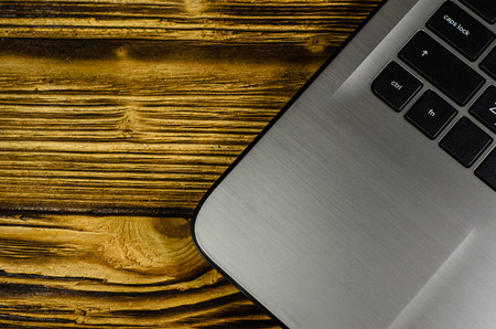 Modern laptop on rustic wooden table. Top viewの写真素材