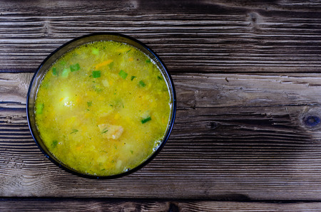 Vegetable soup in glass bowl on wooden table. Top viewの写真素材