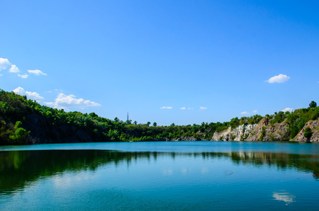 Beautiful lake in abandoned granite quarry on springの写真素材