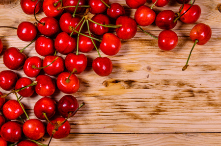 Fresh ripe cherries on rustic wooden table. Top viewの写真素材