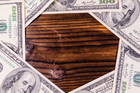 Frame of the one hundred dollars bills on rustic wooden table. Top viewの写真素材