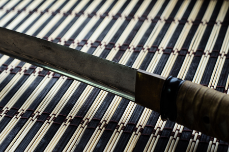 Japanese sword katana on a bamboo matの写真素材