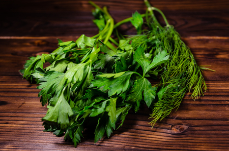 Bunch of parsley and dill on rustic wooden tableの写真素材