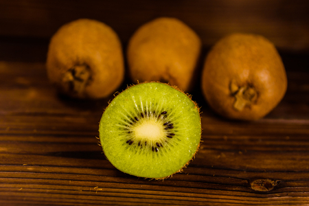 Ripe kiwi fruits on a wooden tableの写真素材