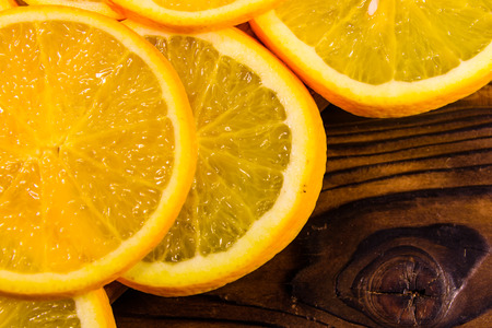 Ripe orange fruits on a wooden table. Top viewの写真素材
