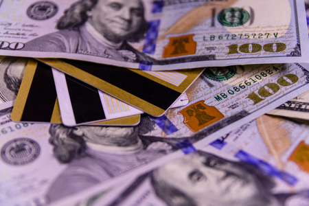 Plastic cards on one hundred dollar billsの写真素材