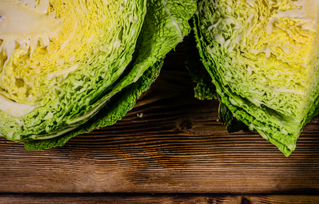 Quarters of the savoy cabbage on wooden tableの写真素材
