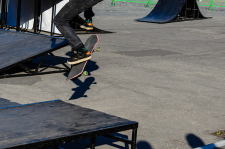 Legs of the skater on a skateboard in skateparkの写真素材