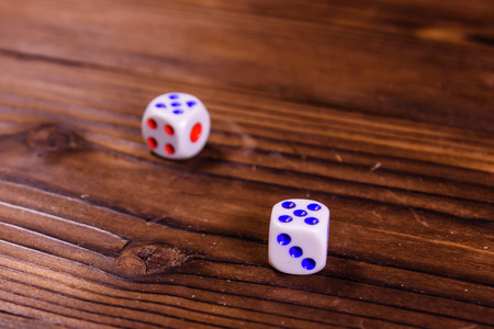 Dice on a rustic wooden table. Gamble conceptの写真素材
