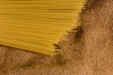 Bunch of spaghetti on rustic sackcloth. Top viewの写真素材