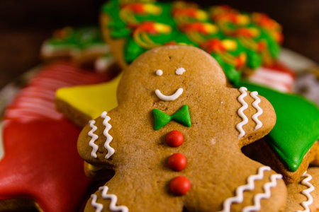 Plate with different christmas gingerbread cookies on rustic wooden table