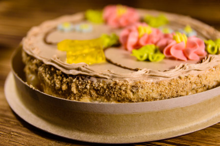 Kiev cake with cream on rustic wooden table