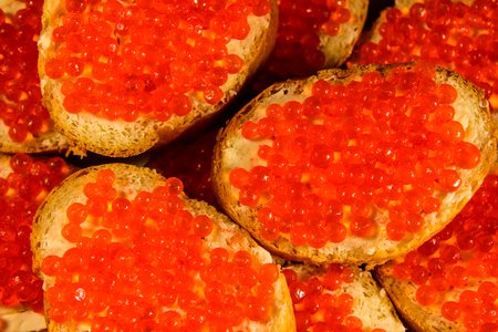 Background of the sandwiches with red caviarの写真素材