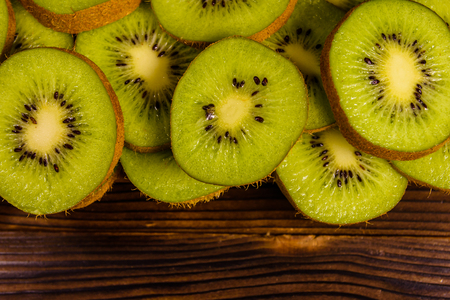 Ripe kiwi fruits on a wooden table. Top viewの写真素材