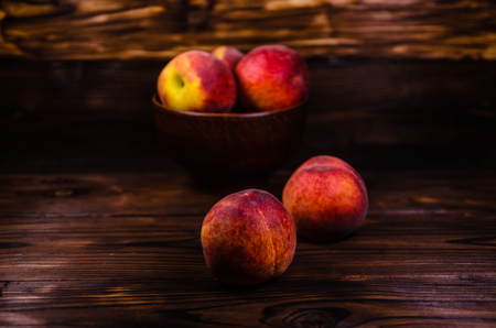 Fresh ripe peaches on rustic wooden tableの写真素材