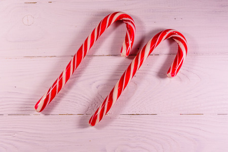 Two candy canes on wooden table. Top viewの写真素材