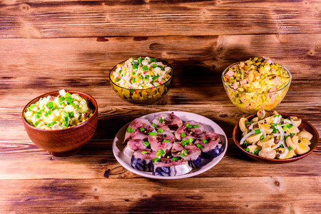 Different festive dishes on rustic wooden tableの写真素材