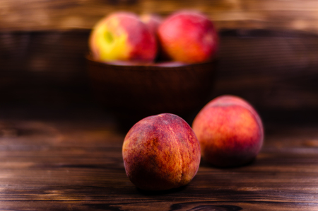 Fresh ripe peaches on rustic wooden tableの写真素材
