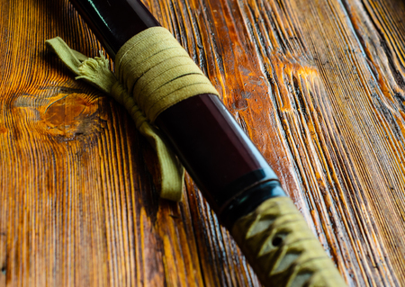 Japanese sword katana on a wooden backgroundの写真素材