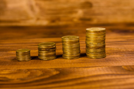 Stack of the coins on rustic wooden table