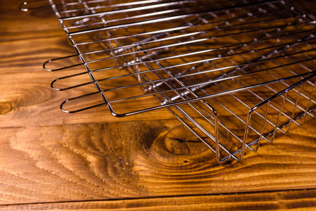Empty barbecue grill on rustic wooden table