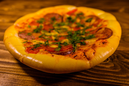 Fresh homemade pizza on rustic wooden tableの写真素材