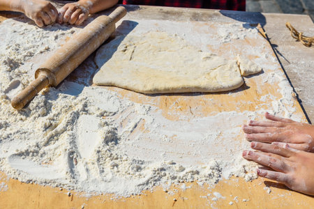 Woman rolling dough with the rolling pin