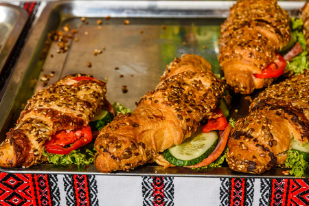 Fresh croissants with ham, tomatoes and cucumbersの写真素材