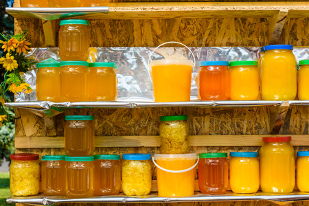 Background of many glass jars with honeyの写真素材