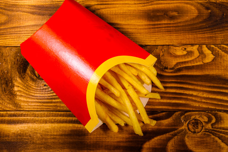 French fries in red box on rustic wooden table. Top viewの写真素材