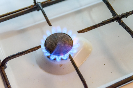 Gas burner on a white kitchen stoveの写真素材