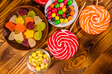 Different sweet candies on rustic wooden table. Top viewの写真素材