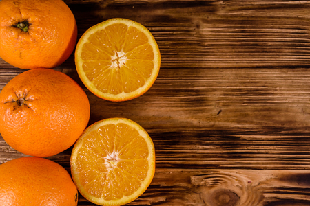 Ripe orange fruits on rustic wooden table. Top viewの写真素材
