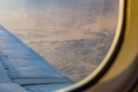 Aerial view on arabian desert and Red sea mountains from airplane windowの写真素材