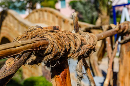 Vintage handrail made of logs and hemp ropes