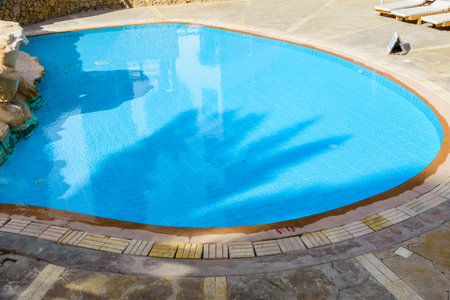 View on swimming pool with turquoise clear waterの写真素材