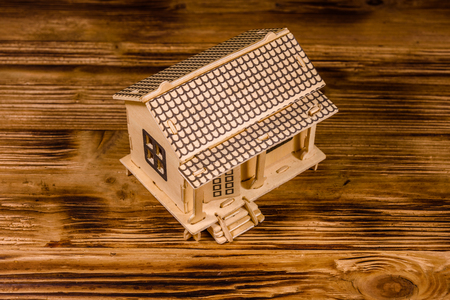 Plywood model of house on wooden tableの写真素材