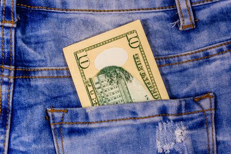 American ten dollar banknotes in pocket of blue jeansの写真素材