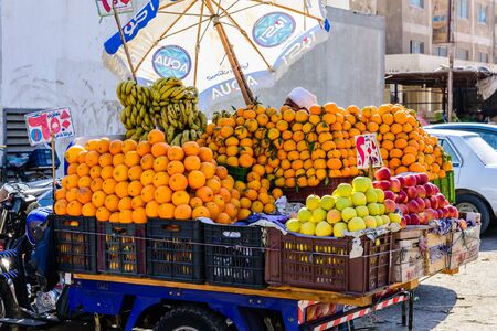 Hurghada, Egypt - December 9, 2018: ripe mandarins and orange fruits for sale on fruit marketのeditorial素材