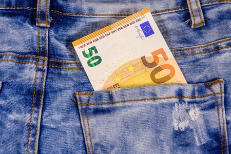 Fifty euro banknote in pocket of blue jeansの写真素材