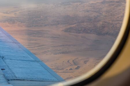 Aerial view on arabian desert and Red sea mountains from airplane windowの写真素材