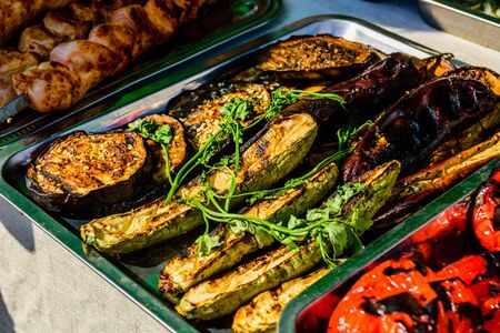 Grilled eggplants and marrows in metal trayの写真素材