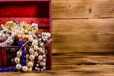 Old box of red wood full of jewelry. Treasure chestの写真素材