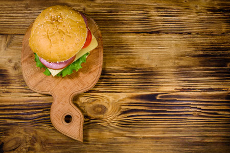 Fresh hamburger on wooden cutting board. Top viewの写真素材